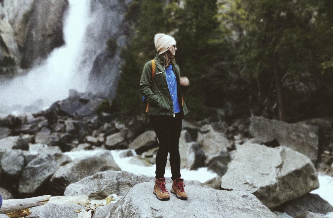 woman on rock in woods